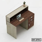 Modern office reception table with wood finish, drawers, laptop, and potted plant