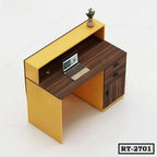 Modern yellow and brown reception desk with drawers, laptop, and small plant for office.