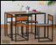 Modern dining table set with four wooden chairs and metal frames, tabletop decor including flowers, coffee cup and moka pot, on wooden floor.
