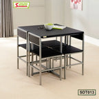 Modern black dining table set with four chairs, metal frame, in a bright living room