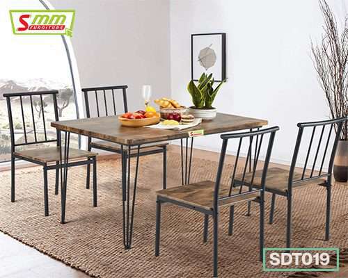 Modern dining table set with four wooden chairs, metal frames, tabletop decor, and fruit bowl Main image