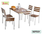 Modern dining table set with four wooden chairs, white metal frames, tabletop with breakfast items.