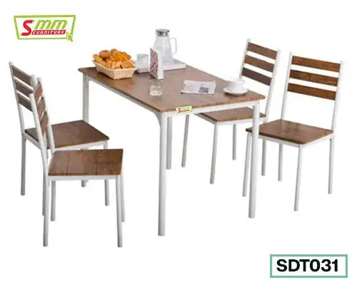 Modern dining table set with four wooden chairs, white metal frames, tabletop with breakfast items.