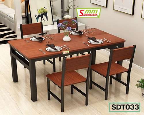 Modern wooden dining table set with four chairs in a bright, stylish living room. Main image