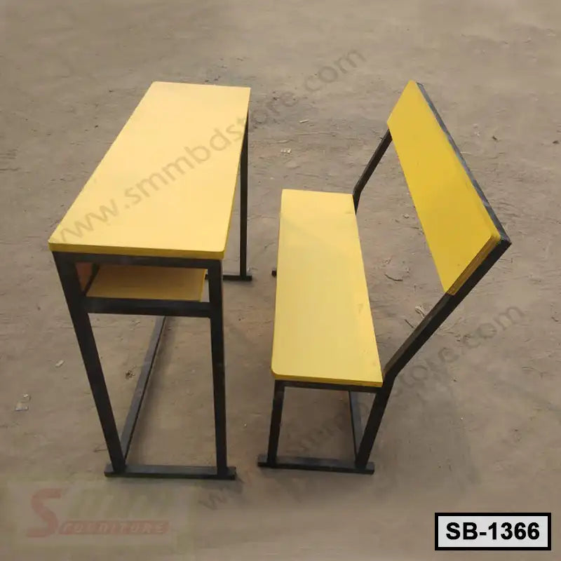 Yellow metal school desk and bench set for classroom furniture on sandy ground