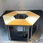 Set of modular hexagonal school benches with light wood surfaces and metal legs in a classroom