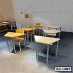 Modern wooden school desks and chairs set in a classroom with grey flooring