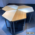 Set of four modular pentagon-shaped school desks with wood and white tops on metal legs