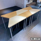 Modern modular school benches with triangular wood and white tabletops on metal legs.