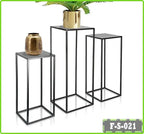 Set of three black metal nesting plant stands with square tops, displaying decorative vases