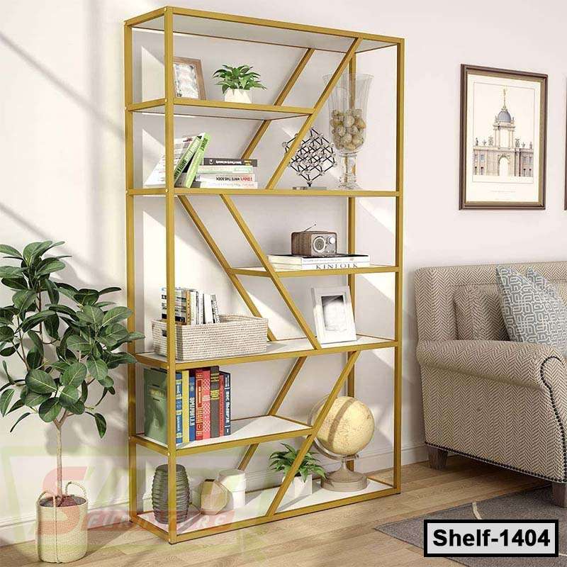 Modern gold metal bookshelf with geometric design, books, decor items, and indoor plants in a living room