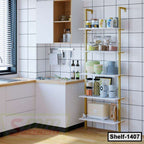 Modern kitchen shelving unit with white shelves and gold frame, kitchenware and groceries displayed.