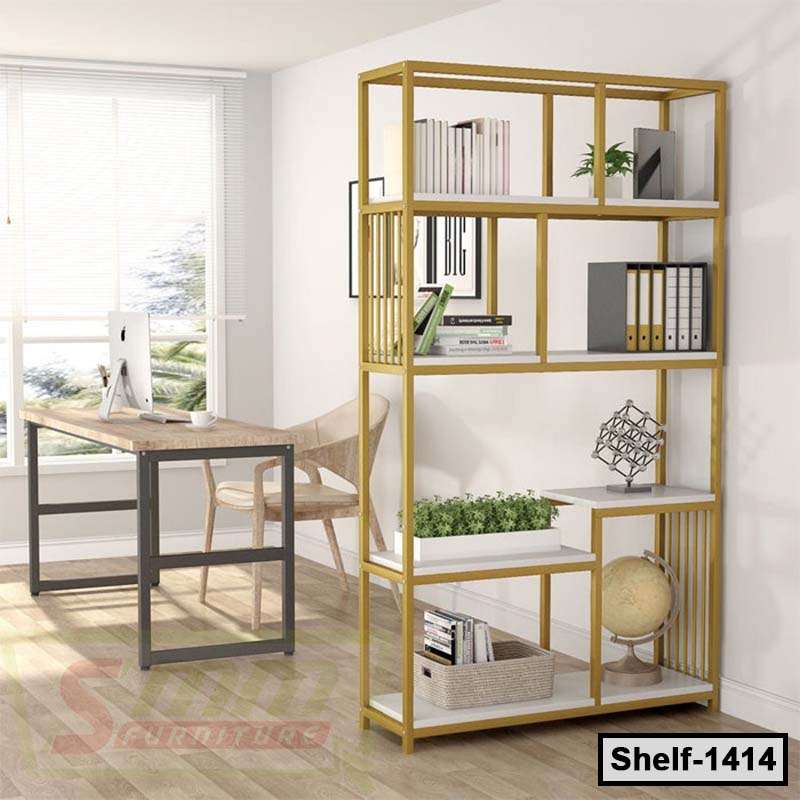 Modern gold metal bookshelf with books, plants, and decor in a bright office setting.