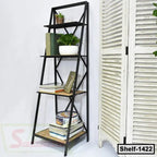 Modern black metal and wood shelf with books, plants, and decor against a white wall