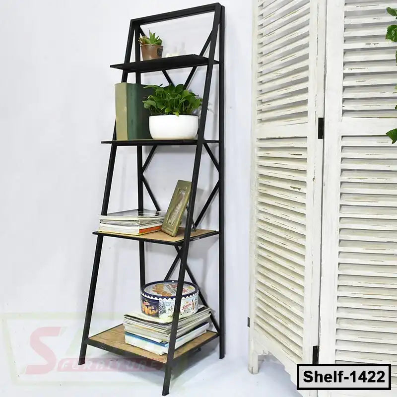 Modern black metal and wood shelf with books, plants, and decor against a white wall