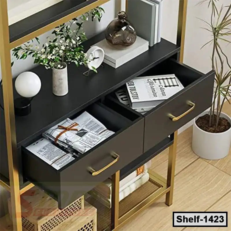 Modern black and gold shelving unit with drawers, books, plants, and home decor accessories.