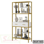 Modern gold and white metal bookshelf with drawers and decorative items, ideal for home or office