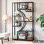 Modern black metal bookshelf with decorative items, books, and plants in a stylish living room