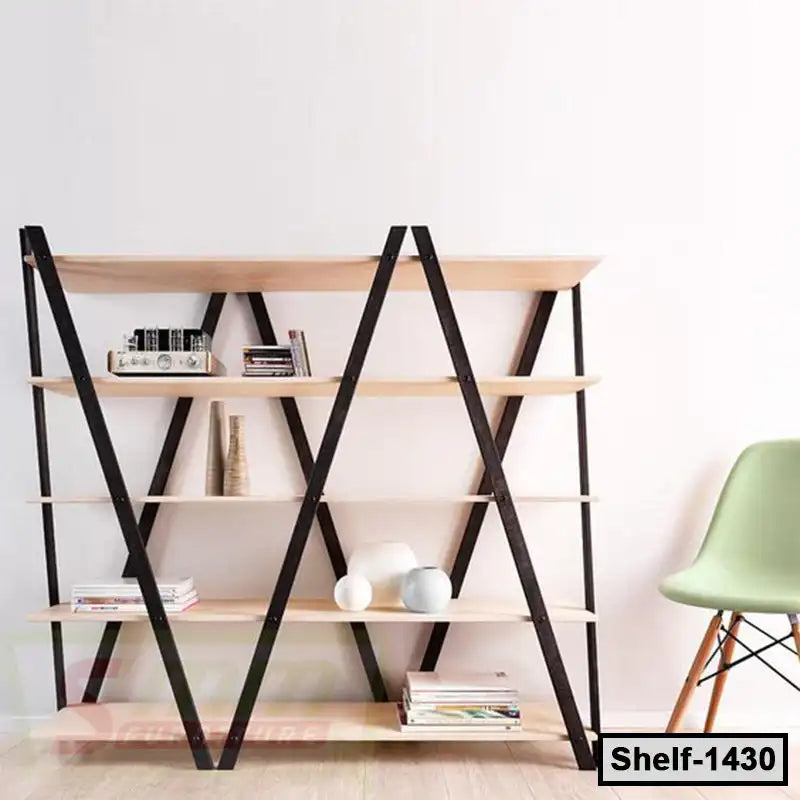 Modern wooden bookshelf with black metal frame, decorated with books and vases, beside a green chair Main image