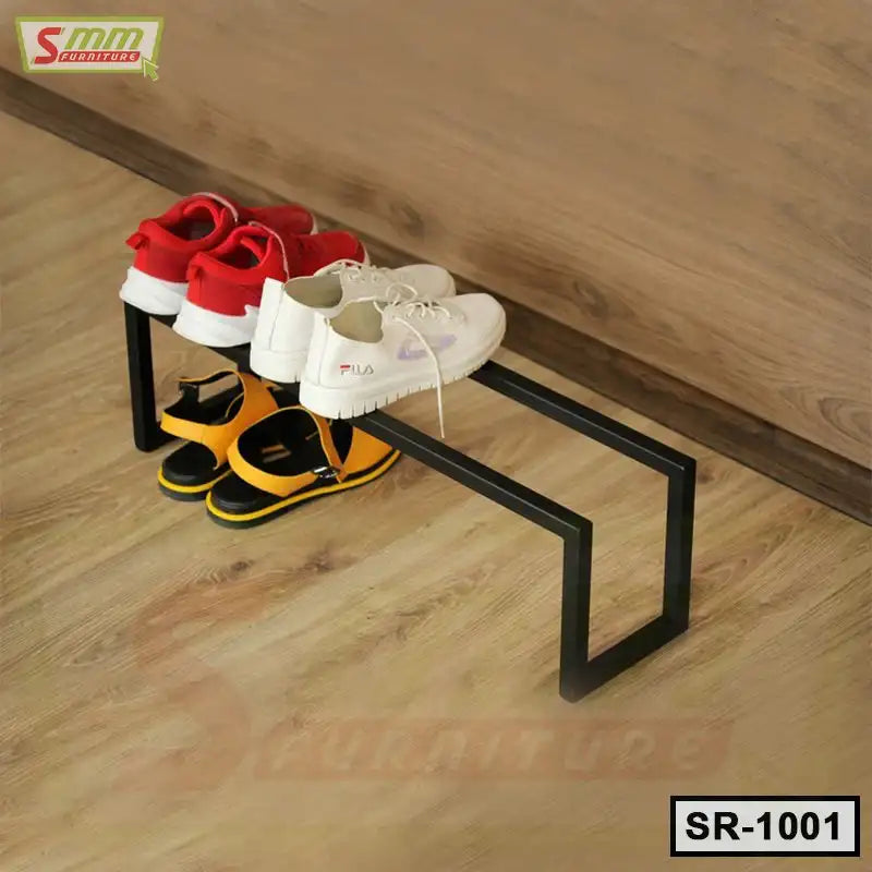 Modern black metal shoe rack on wooden floor holding sneakers and sandals