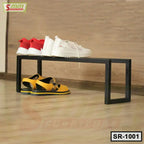 Modern black metal shoe rack with sneakers and sandals on wooden floor, minimalist design