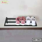 Wall-mounted black metal shoe rack with pink and white sneakers, minimalist design