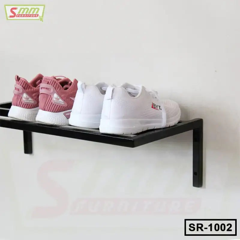 Wall-mounted metal shoe rack holding pink and white sneakers, space-saving shoe storage