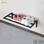 Wall-mounted metal shoe rack with pink and white sneakers, modern home organization
