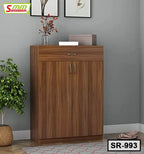 Modern wooden shoe rack with double doors and storage drawer in a home interior