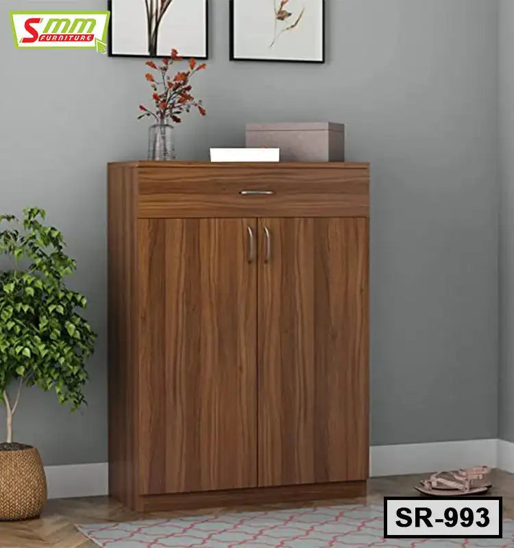 Modern wooden shoe rack with double doors and storage drawer in a home interior