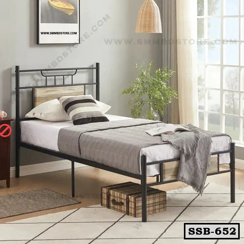 Single steel bed with gray bedding in modern bedroom, large window, and cozy decor