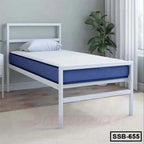 Modern single steel bed with headboard, blue mattress, in a bright bedroom with plant