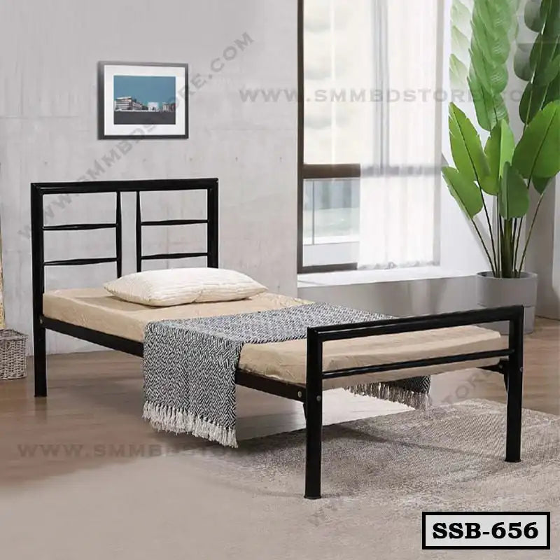 Modern single steel bed with beige mattress in a bright bedroom setting, indoor plant nearby Main image