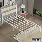 Modern single steel bed frame in white, placed in a bright bedroom with wooden floor.