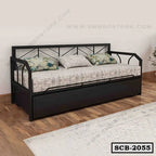 Modern black metal sofa cum bed with patterned cushions in a minimalist living room