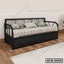 Modern black metal sofa cum bed with patterned cushions in a minimalist living room