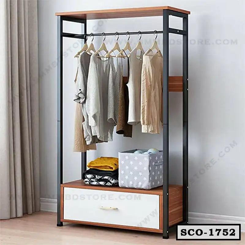 Standing closet organizer with hanging clothes, shelves, and storage drawer in a bedroom. Main image