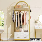 Modern standing closet organizer with drawers, shelves, and hanging clothes in a bedroom.