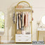 Modern standing closet organizer with drawers, shelves, and hanging clothes in a bedroom.
