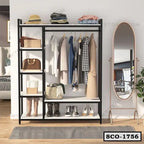 Modern standing closet organizer with shelves, hanging clothes, and shoes in a bedroom.