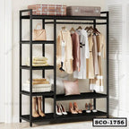 Standing closet organizer with black frame, open shelves, and clothes hanging, plus shoes and bags