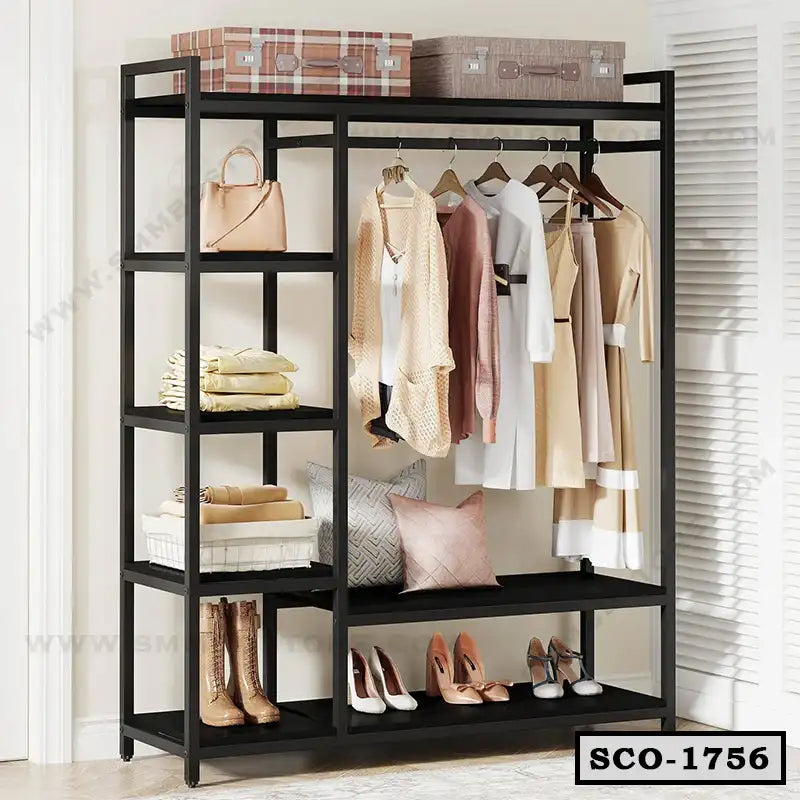 Standing closet organizer with black frame, open shelves, and clothes hanging, plus shoes and bags