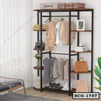 Modern standing closet organizer with metal frame and wooden shelves, hanging clothes, bags, and shoes in a contemporary bedroom setting.
