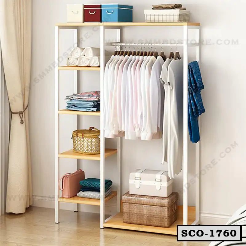 Standing closet organizer with hanging clothes, open shelves, and storage baskets in a modern room Main image