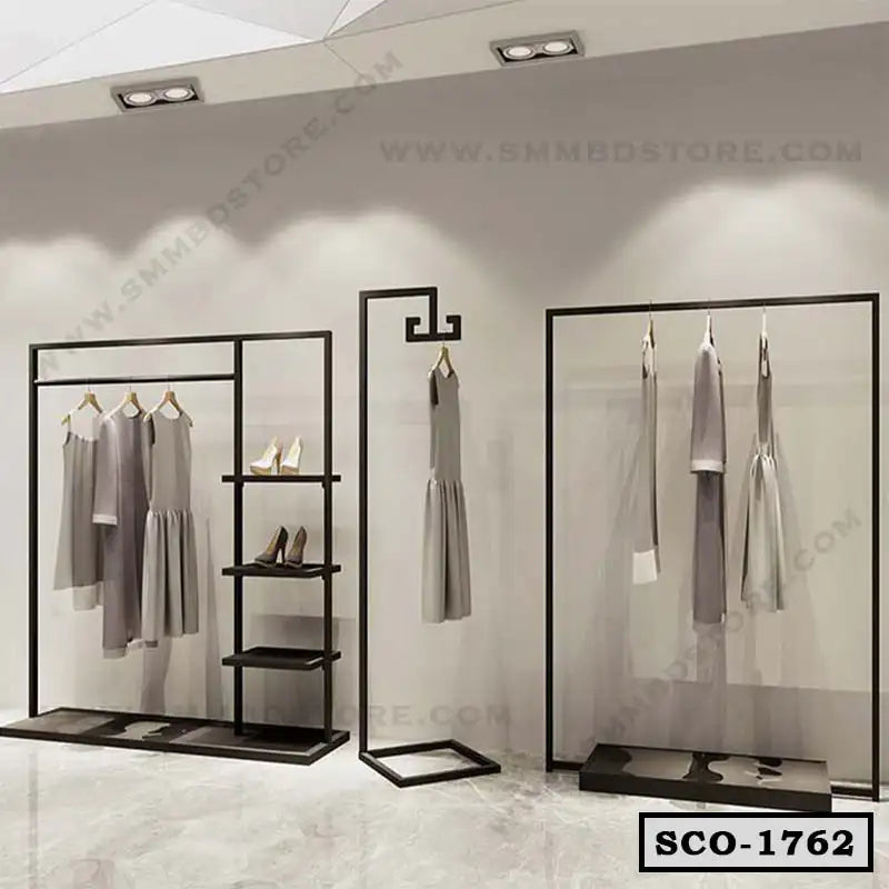Modern standing closet organizer with black metal frame, shelves, and hanging clothes in a showroom Main image