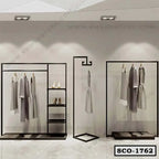 Modern black metal standing closet organizer with shelves, dresses, and shoes on display