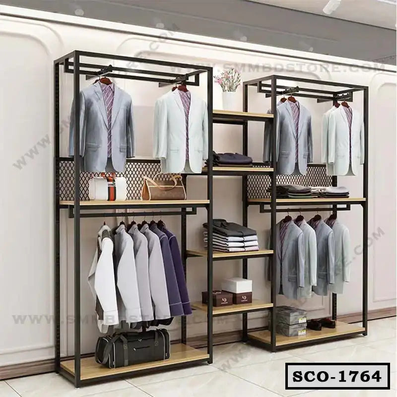 Standing closet organizer with black metal frame, wooden shelves, and hanging suits