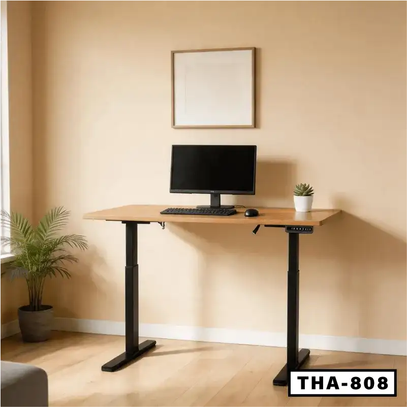 Modern standing desk with double motors, wooden top, monitor, keyboard, and potted plant in a home office