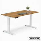 Adjustable standing desk with wooden top, white frame, laptop, books, and small plant