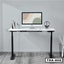 Modern standing desk with white tabletop, double motors, and computer setup in home office